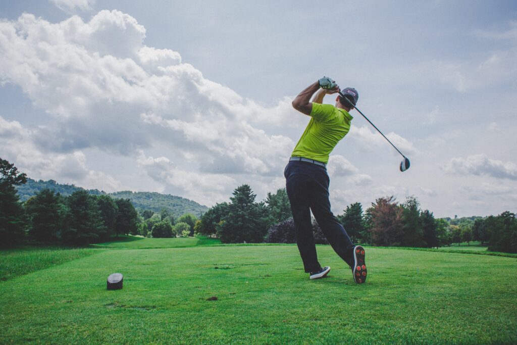 Man on the golf course swinging his golf club