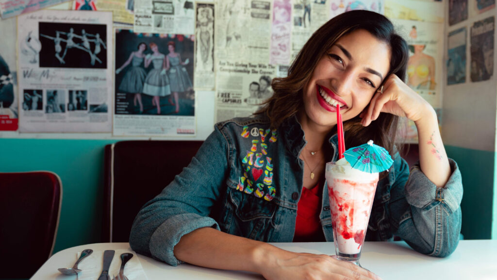 Lady at a restuarant enjoying an ice cream shake